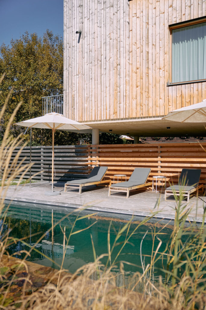 Detail of the Aerli designer holiday home with wooden façade, sun terrace and natural pool