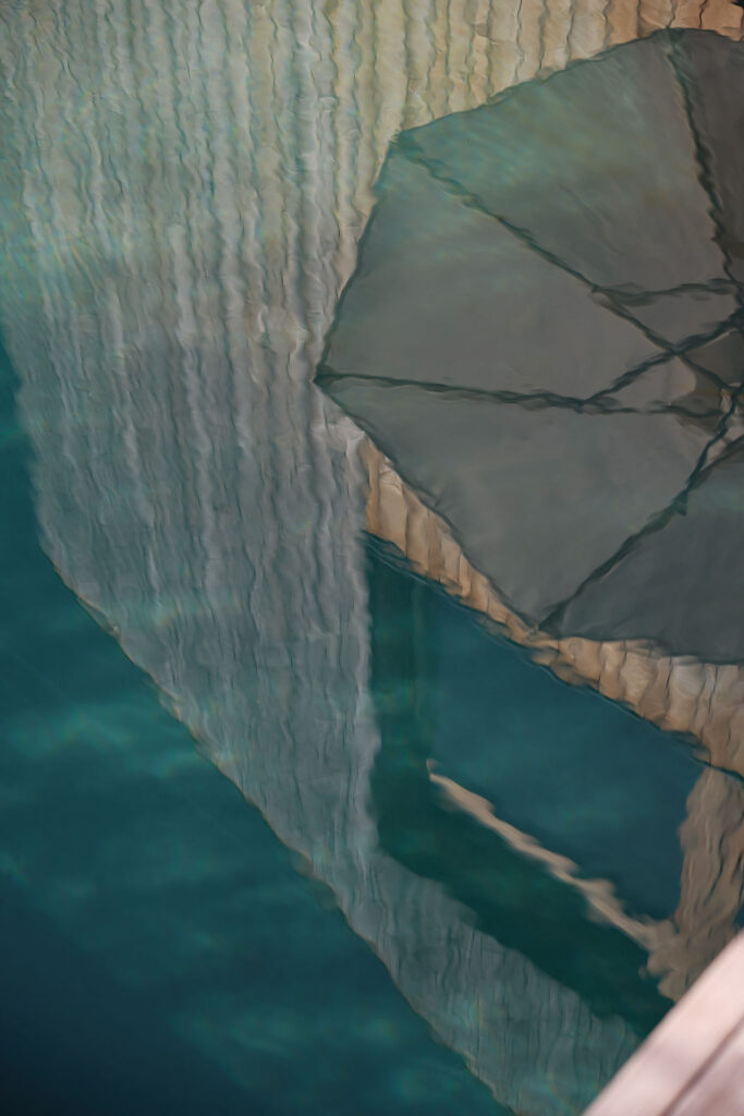 Reflection of the Aerli design house and parasol in the natural pool.